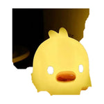 Yellow duck silicone night light on a plain background